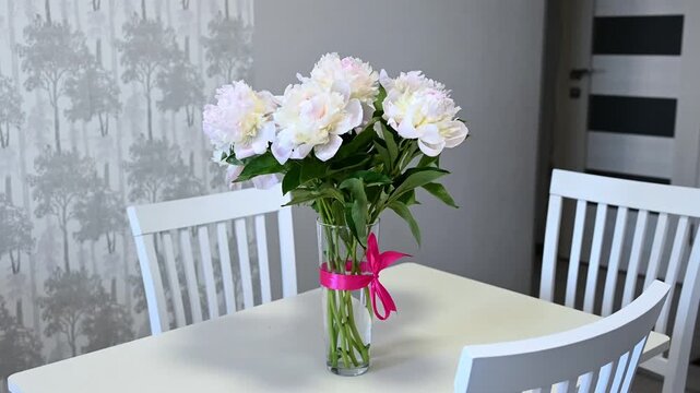 Fresh Light Pink Peonies with a Bright Bow in a Modern Kitchen Interior