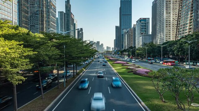 Traffic on modern landscaped boulevard between skyscrapers in a business district