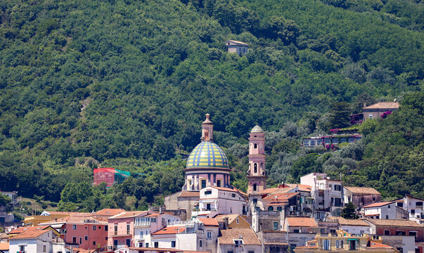 The vibrant coastal village of Vietri sul Mare with view of the Historic Church of San Giovanni Batista tiled dome along the famous Amalfi Coast in Italy.