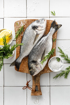 Fresh raw dorado fish cooking with ingredients. Sea bream, dorado. Seafood, healthy food. Top view