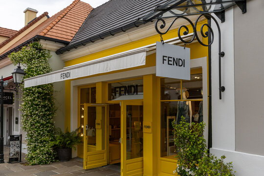 Fendi Store Facade with Yellow Accents at La Vallee Village, France.
