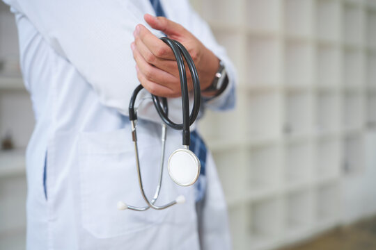 Healthcare professional holding a stethoscope, prepared for medical examination or consultation