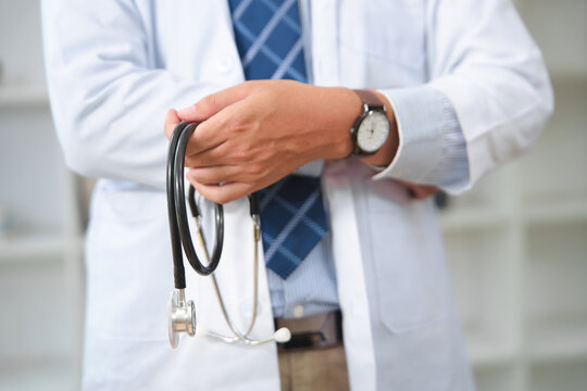 Medical professional holding a stethoscope in a clinical setting