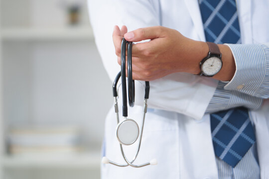 Doctor Holding Stethoscope in Medical Office Setting for Healthcare Promotion
