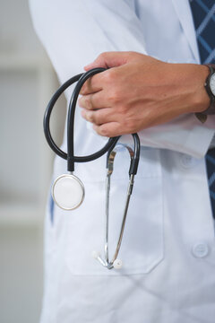 Medical Professional Holding Stethoscope in Healthcare Setting