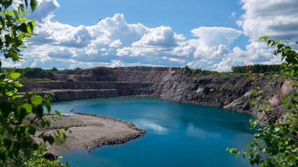 Beautiful landscape of a flooded marble quarry with steep stone shores and turquoise water in Karelia, Russia. © Mikhail Andreev