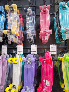 Voronezh, Russia - April 11, 2026.Brightly colored Termit and Denton penny boards displayed for sale in a sports market in Russia on a busy shopping day
