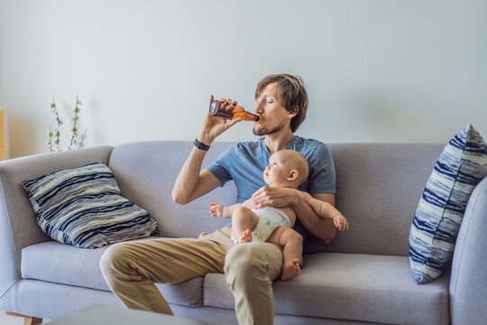 Stressed father sitting on couch holding baby and drinking beer at home. Exhausted parent struggling with responsibility and alcohol. Parenting stress, addiction and mental health concept