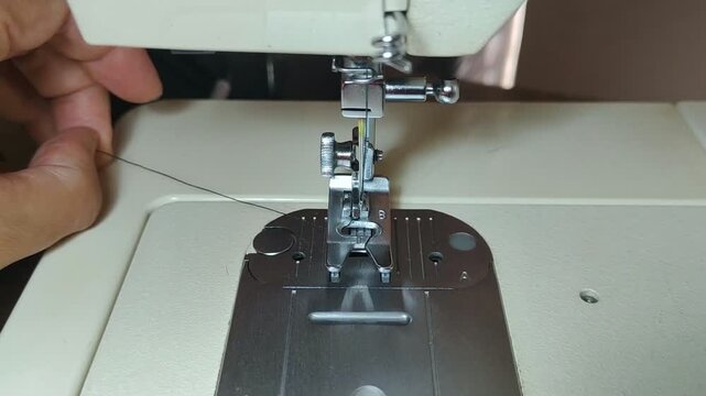 Threading the needle of a sewing machine