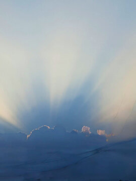 Sunrays behind clouds at sunse