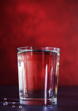 clear beverage on a red background