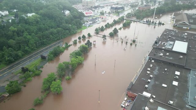Massive floodwaters overwhelm cars and roads in Bedford, Halifax after relentless rain and hurricane conditions. The local river exceeds its banks, creating chaos
