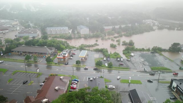 In Bedford, Halifax, floods submerge cars and roads as a river overflows its banks. This extreme weather event showcases the power of nature during a major storm