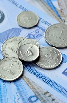 UAE dirham money bills and coins on table. United Arab Emirates cash of AED currency close up