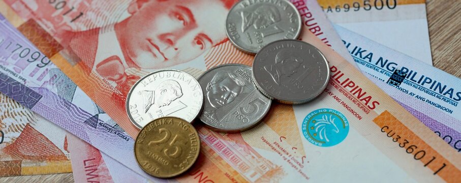 Philippine peso money bills and coins on table. Philippines cash of PHP currency close up