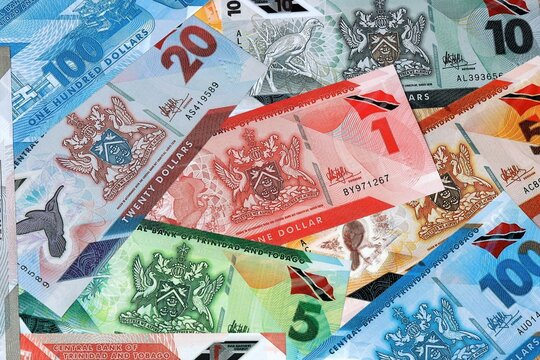Trinidad and Tobago dollar money banknotes bunch on table. Trinidad and Tobago bills of TTD currency