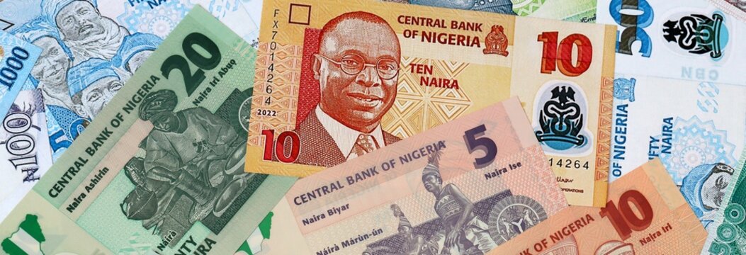 Nigerian naira money banknotes bunch on table. Nigeria bills of NGN currency close up