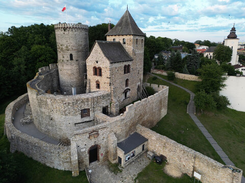 Aerial view of the medieval Bedzin Castle and the Holy Trinity Church tower at sunset, Poland.