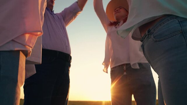 Business partners raise their hands in gesture cooperation, team goal achievement, results. Business people raising hands signify team success team cohesion. Teamwork business. Farming team outdoors.