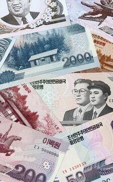 North Korean won money bills in pile on table. North Korea KPW currency cash close up