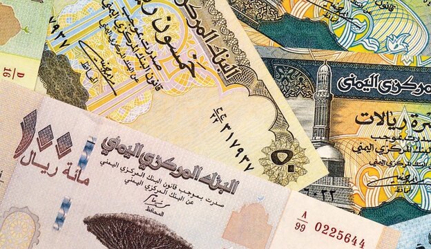 Yemeni rial money bills in pile on table. Yemen YER currency cash close up