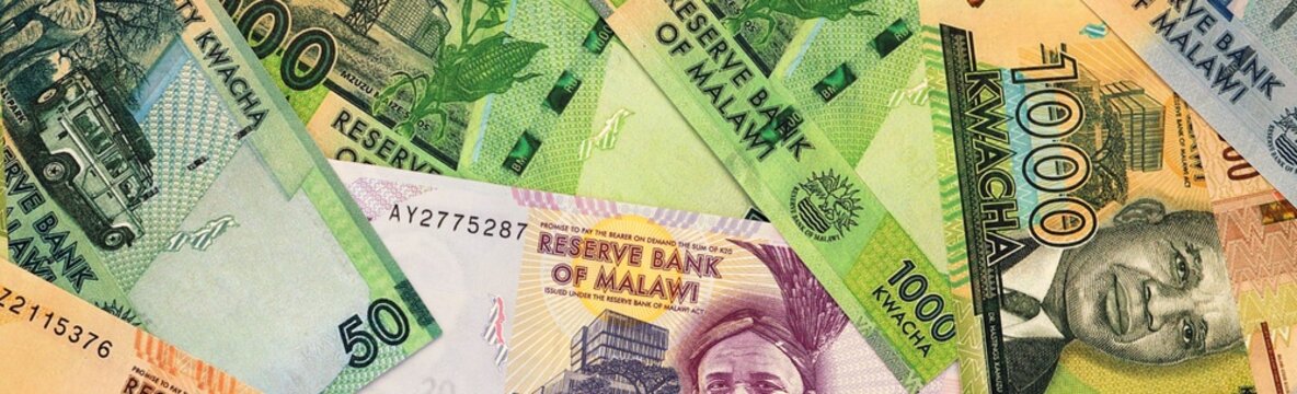 Malawian kwacha money bills in pile on table. Malawi MWK currency cash close up