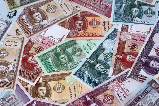 Mongolian tugrik money bills in pile. Big amount of Mongolia MNT currency cash close up