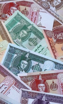 Mongolian tugrik money bills in pile. Big amount of Mongolia MNT currency cash close up