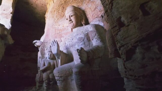 Yungang, China - May 9 2026: Majestic Buddha statue in the Yungang Grottoes, embodying spiritual serenity, monumental artistry, and the rich heritage of ancient Chinese Buddhist culture