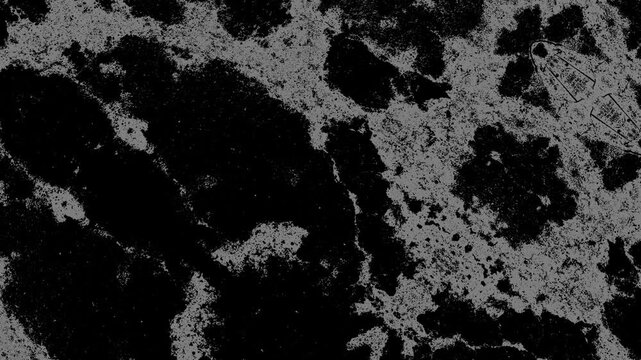 Abstract black and white grunge texture with irregular patches, rough grain, and weathered surfaces. Grunge texture background animation.