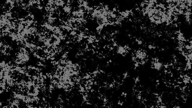 Abstract black and white textured pattern with mottled surfaces, rough grain, and strong contrast. Grunge texture background animation.