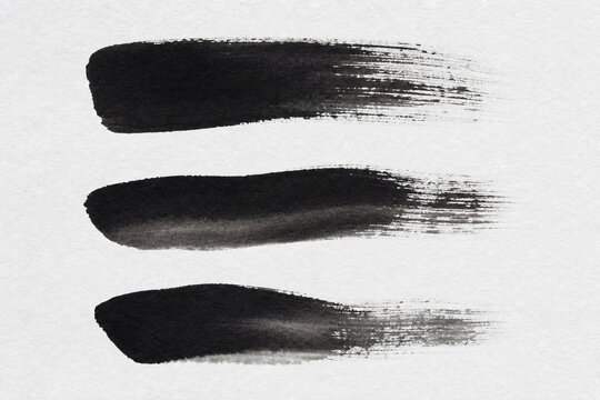 Black sumi ink brushstrokes dry brush texture washi paper