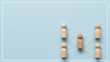 Obraz premium Wooden figures connected by lines, symbolizing teamwork or collaboration.
