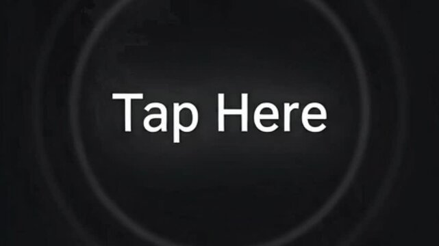 A dark screen with a white "Tap Here" text inside a subtle circular outline, indicating an interactive element or call to action.