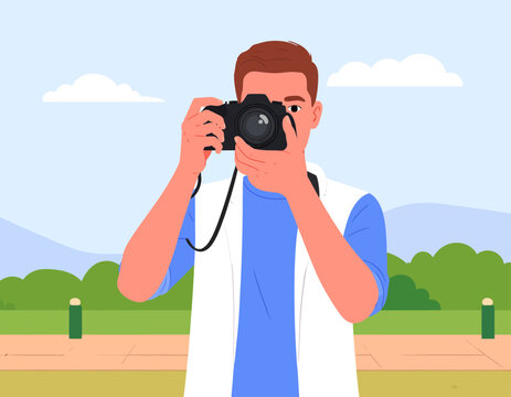 A man holding a black DSLR camera and looking through the viewfinder, ready to take a photo in a park.
