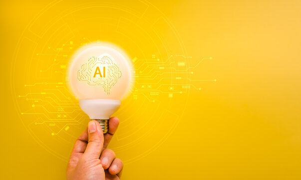 Hand holding glowing AI light bulb with digital circuit pattern on yellow. Artificial intelligence innovation, creative technology, machine learning, futuristic ideas and smart digital transformation.