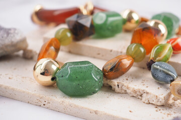 Colorful beads are arranged on a stone surface © Towfiqu Barbhuiya 