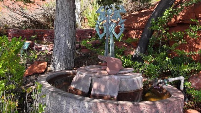 Metal Prayer Wheel Sculpture Against Red Rock Formation in Sedona 2