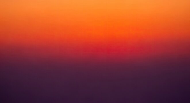 Vibrant gradient background with orange, red, and purple hues blending smoothly