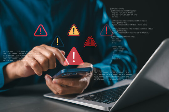 Warning signs show computer cybersecurity threats like data hacking and ransomware, phishing and spyware alert user of cybercrime attack as warning triangle alert symbols show on phone screen