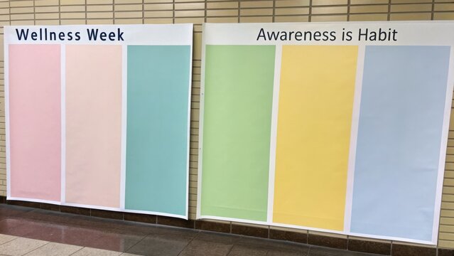 Colorful Wall Banners Promoting Wellness Week and Encouraging Habitual Awareness in a Bright Indoor Space