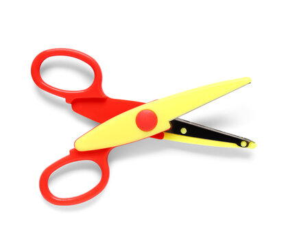 Red and yellow plastic safety scissors for childrens craft activities and school supplies, isolated on white background