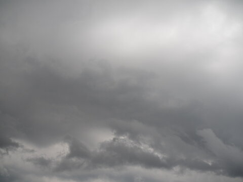 The sky was dark and rain was imminent. Large, gray clouds hung in the sky; it looked gloomy and not bright.