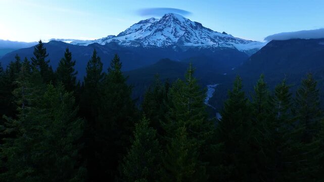 Mount Rainier And Forested Valley Under Fading Evening Light