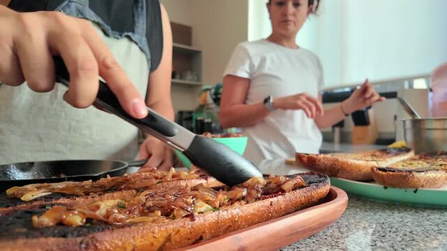 Woman preparing delicious bruschetta with caramelized onions