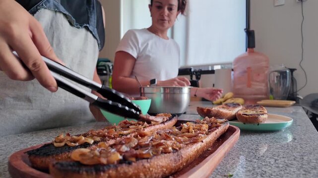Female chefs preparing delicious gourmet baguette sandwich