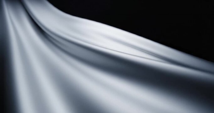Smooth, flowing fabric draping elegantly with soft light creating a serene atmosphere