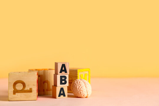 Aba therapy with wooden blocks and brain model for autism spectrum disorder treatment and child development, it highlights educational and developmental support for children with special needs