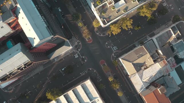 Aerial View of City Intersection: An overhead perspective reveals a busy urban intersection with buildings, roads, and trees.