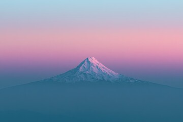 Fototapeta premium Majestic snow-capped mountain peak emerges from misty blue lowlands